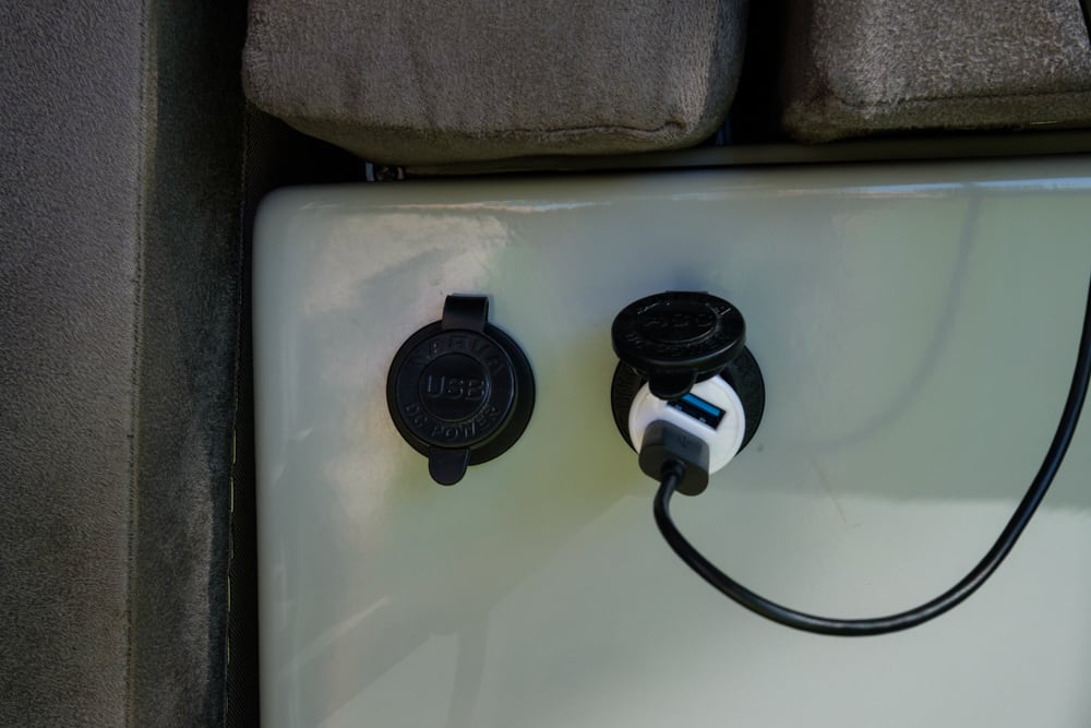 Sockets under the bench seat, left is USB, right is cigarette lighter